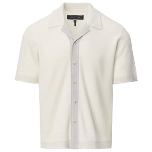 The Harvey Camp Shirt by Rag & Bone is a white short-sleeve knit shirt with textured button-up design, featuring a light gray vertical stripe along the placket and an open collar for retro flair.