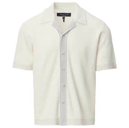 The Harvey Camp Shirt by Rag & Bone is a white short-sleeve knit shirt with textured button-up design, featuring a light gray vertical stripe along the placket and an open collar for retro flair.