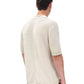 A person is shown from the back wearing the Rag & Bone Harvey Chevron Johnny Polo in light beige with short sleeves and no buttons, paired with olive green pants, against a white background.