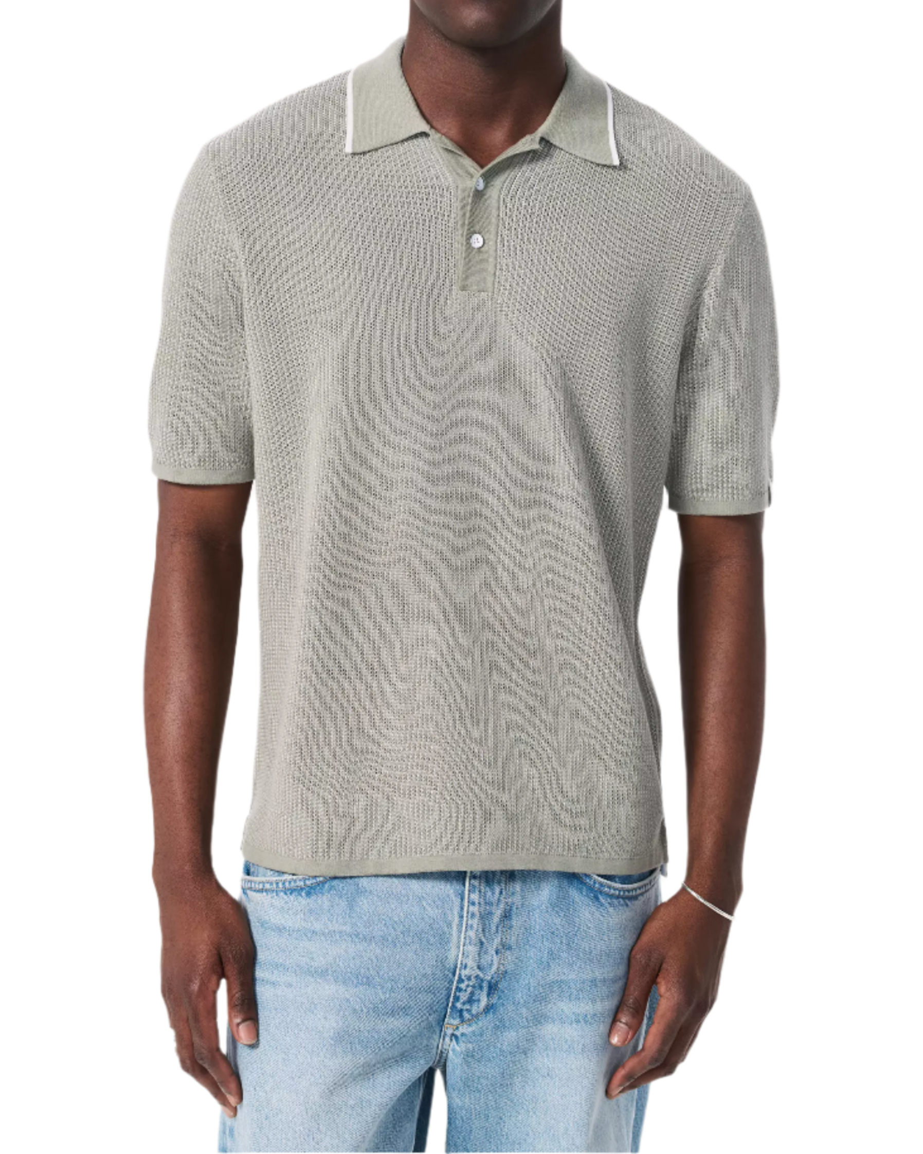 A man wears the Rag & Bone Harvey Knit Polo Shirt in light gray—a vintage-inspired, lightweight cotton blend short-sleeve top—paired with light blue jeans, standing against a white background.