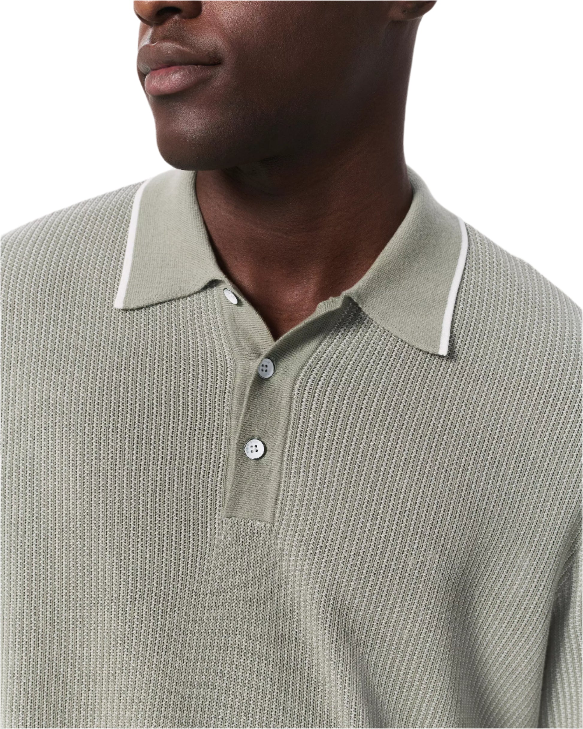 A man wears the Rag & Bone Harvey Knit Polo Shirt, a light green textured cotton-blend polo with white-tipped collar and buttons, shown from the shoulders up against a white background.