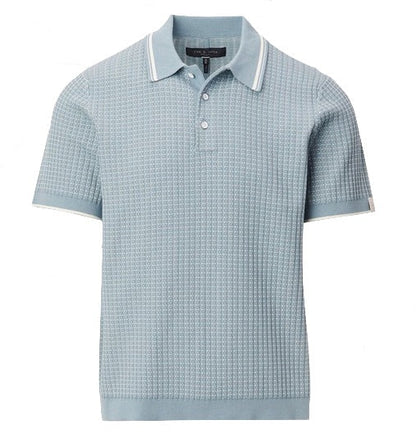 The Harvey Rib Polo by Rag & Bone is a light blue short-sleeve cotton-blend sweater featuring a textured pattern, white stripes on the collar and sleeves, and a three-button neckline.