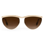 The Krewe Heidi Sunglasses feature a gold frame, brown gradient lenses, and an architectural metal brow bar, shown from the front against a white background.