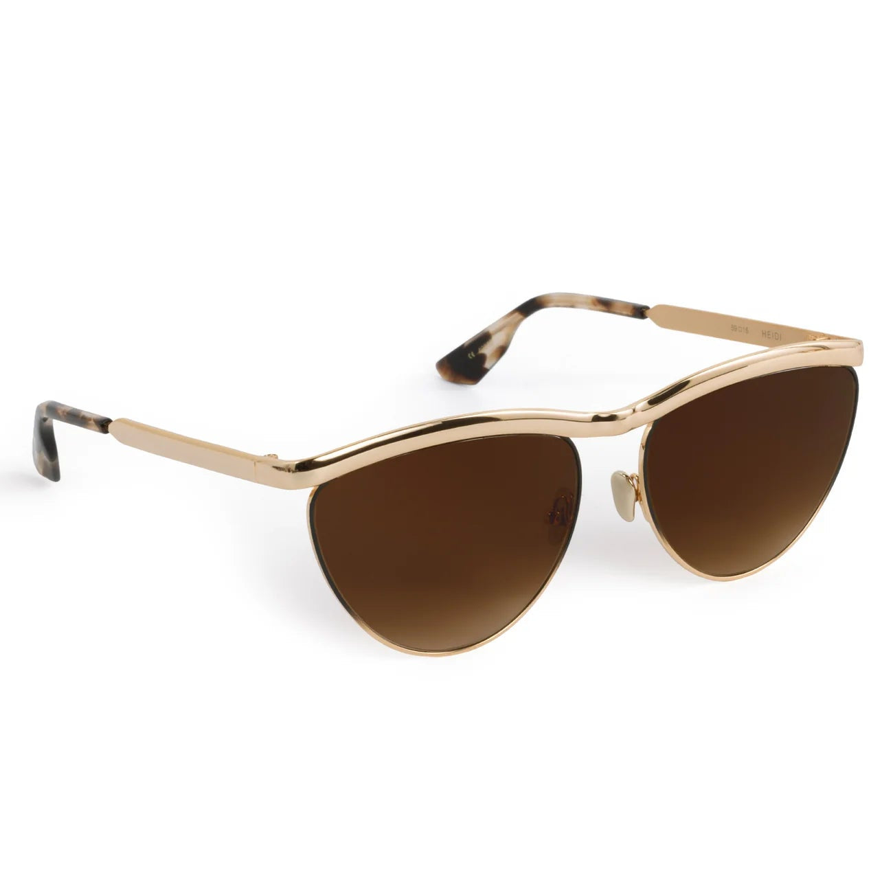 Krewe's Heidi Sunglasses feature gold cat-eye frames, brown tinted lenses, an architectural metal brow bar, and tortoiseshell-patterned temple tips, shown on a white background.