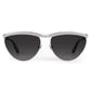 The Krewe Heidi Sunglasses feature vintage-inspired cat-eye silver frames, an architectural metal brow bar, and dark lenses, displayed from the front on a white background.
