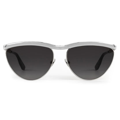 The Krewe Heidi Sunglasses feature vintage-inspired cat-eye silver frames, an architectural metal brow bar, and dark lenses, displayed from the front on a white background.