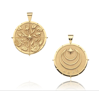 The Jane Win Pendant Necklace Collection features two round gold pendants: one with embossed flowers, the other with triple crescent moons, a star, and "HOPE" engraved—beautiful milestone jewelry pieces.