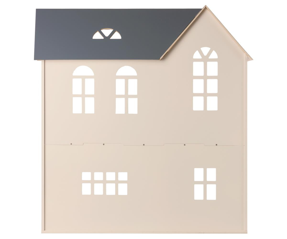 Introducing the Maileg Dollhouse, House of Miniature by Maileg: a minimalist wooden facade featuring a stylish gray gable roof. This cream-colored structure boasts six arched windows and three rectangular ones, making it perfect for showcasing your Maileg furniture. Easy to assemble, this dollhouse seamlessly blends simplicity with charm.