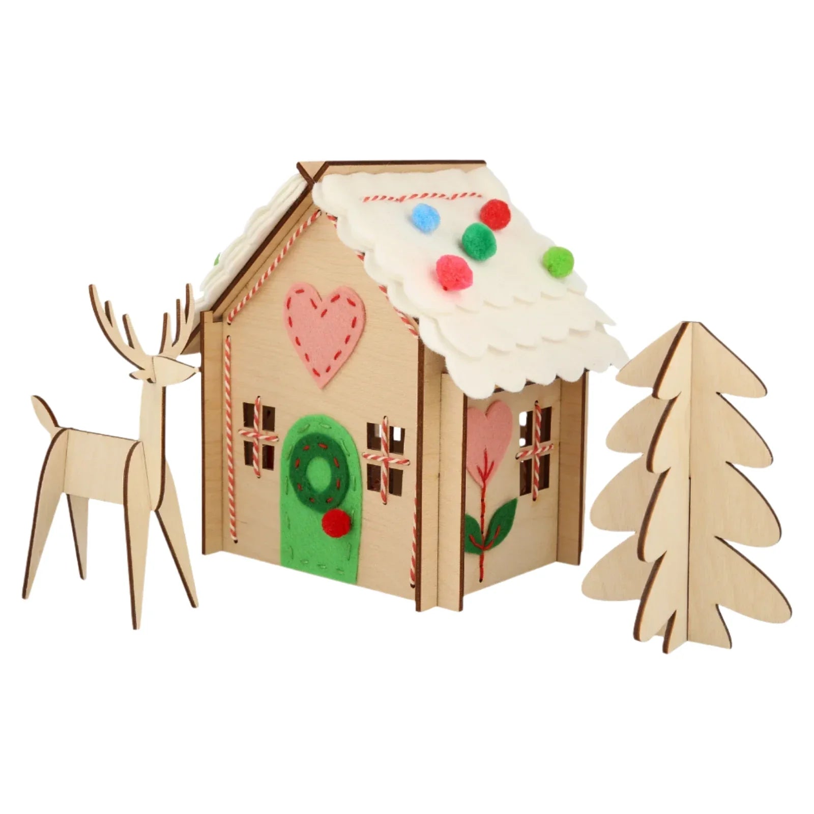 A charming and creative Christmas gift, the Meri Meri Wooden Embroidery Gingerbread House Kit by Meri Meri features a small wooden model house with a green door, colorful decorations, and a white roof. It comes complete with a wooden reindeer and tree, perfect for any imaginative child.