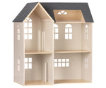 Introducing the Maileg Dollhouse, House of Miniature by Maileg: a three-story wooden dollhouse featuring a black roof, large windows, and multiple rooms. This charming abode is easy to assemble and perfect for fitting your beloved Maileg furniture.