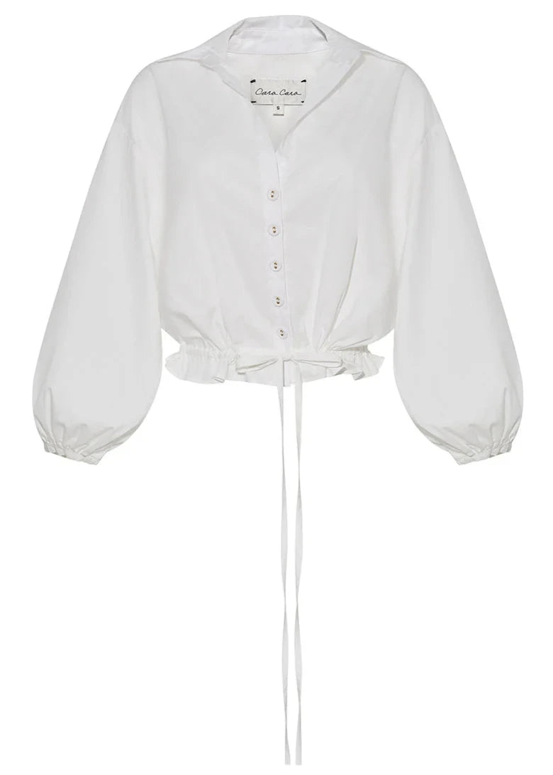 Cara Cara Hutton Top by Cara Cara is a white long-sleeve cotton blouse featuring buttons, puffed sleeves, and a drawstring waist for a chic cropped silhouette.