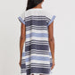 A person with long dark hair is seen from the back wearing the Lemlem Elina Caftan, a short-sleeve, knee-length cotton A-line dress featuring horizontal blue, white, and black stripes.