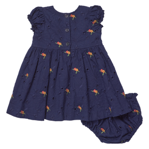 Dress your little one in the Baby Girls' Eliza Eyelet Embroidery Dress Set by Pink Chicken, featuring short sleeves and elegant navy floral embroidery, complete with matching bloomers and convenient buttons down the back for easy dressing.