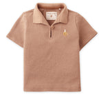 The Gingersnaps Baby Boys' Timmy Waffle Knit Polo Shirt features short sleeves, a light brown color, a collar, and a small embroidered banana logo on the chest—perfect for stylish baby wear.