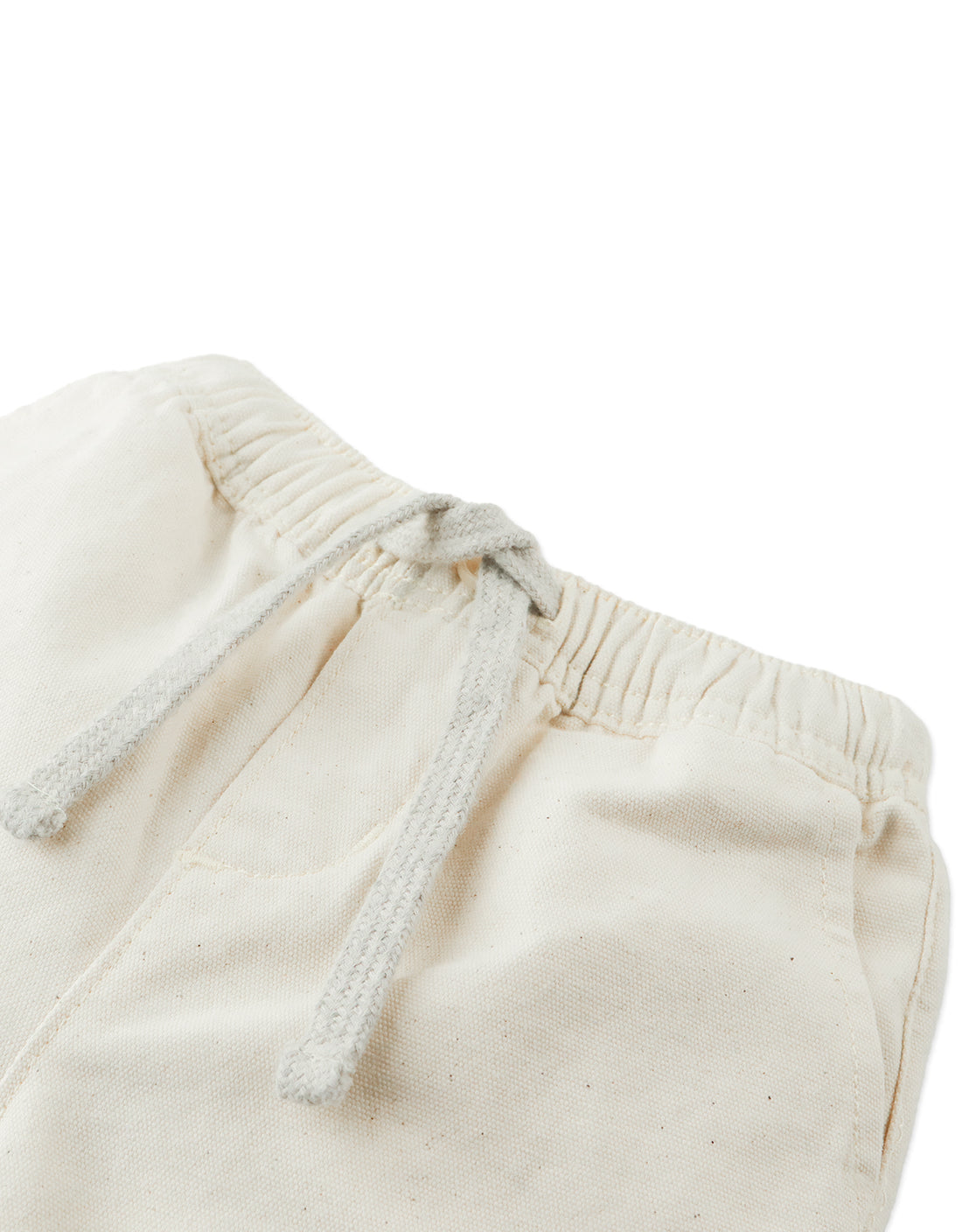 Close-up of the waistband on Gingersnaps Baby Boys' Huey Garterized Drawcords Shorts, featuring offwhite canvas, an elastic band, a drawstring, and a visible front pocket.