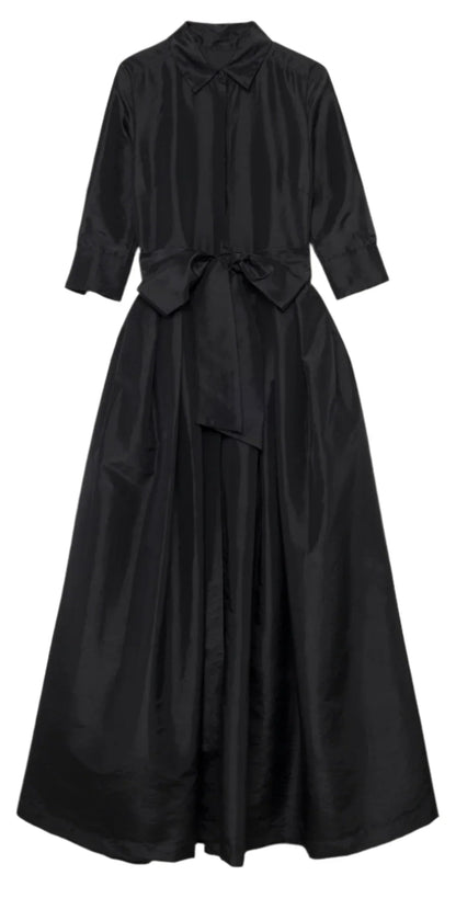 Introducing the Simkhai Julip Belted Gown by Simkhai: a long-sleeved black dress with a collar and button-down front, featuring tailored details, a tied waist belt, and a flowing, full-length skirt.