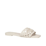 The Dion Woven Slide by Simkhai features a white woven vegan leather upper strap and an open toe design, showcased against a plain white background to emphasize its distinctive texture.