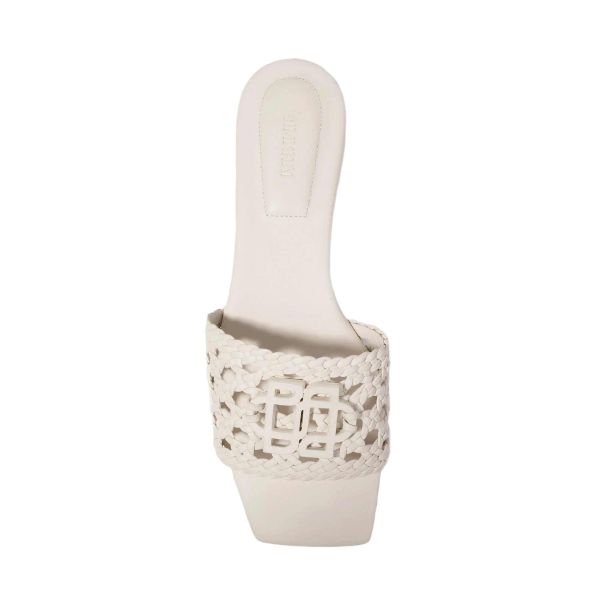 The Simkhai Dion Woven Slide is a white, open-toe mule sandal with a braided vegan leather upper and a modern square toe.