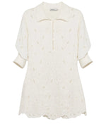 The Freya Linen Dress by Simkhai is a cream-colored, collared mini dress with three-quarter sleeves and a subtle eyelet pattern—ideal as an embroidered linen dress or stylish cover-up.