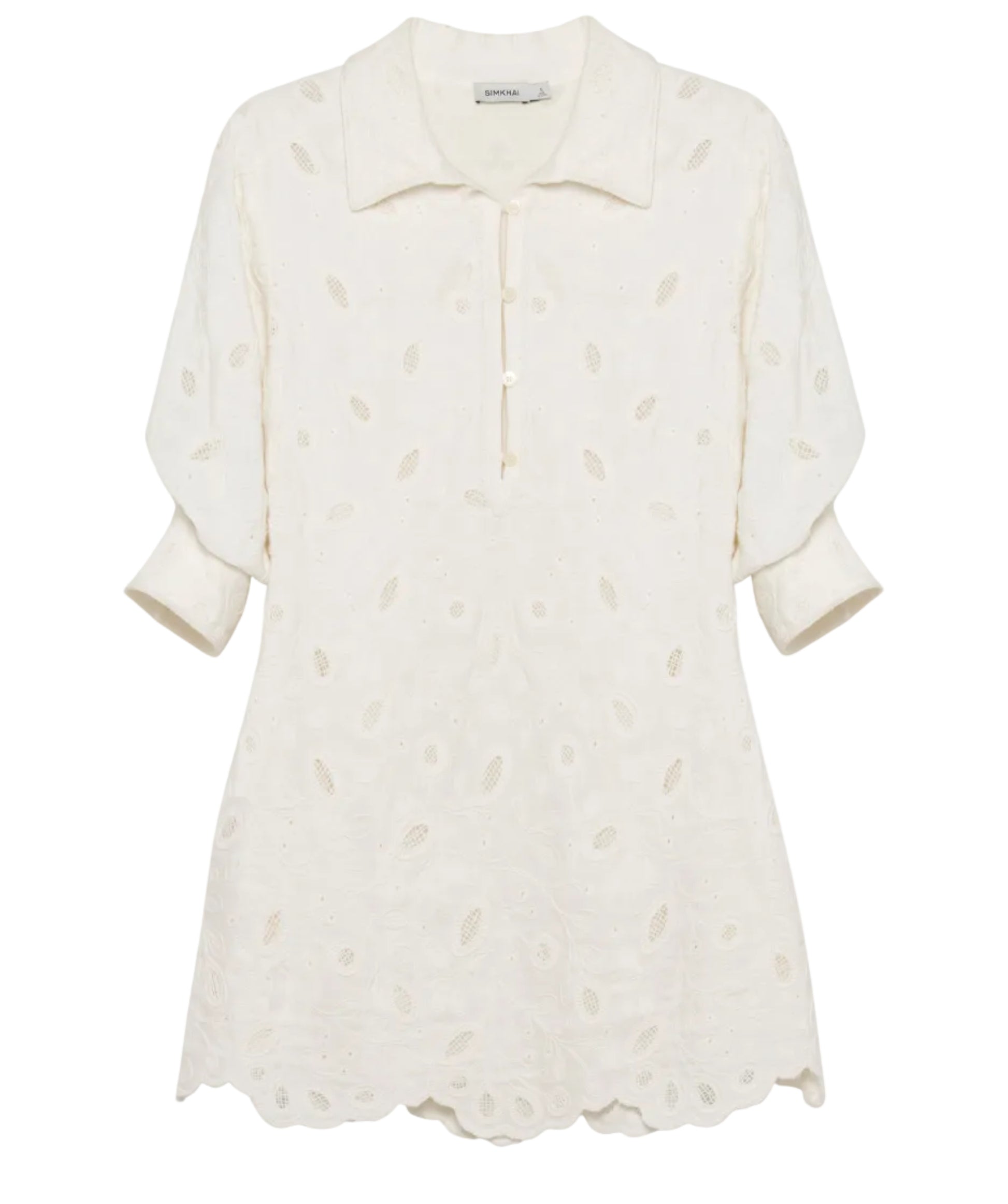 The Freya Linen Dress by Simkhai is a cream-colored, collared mini dress with three-quarter sleeves and a subtle eyelet pattern—ideal as an embroidered linen dress or stylish cover-up.