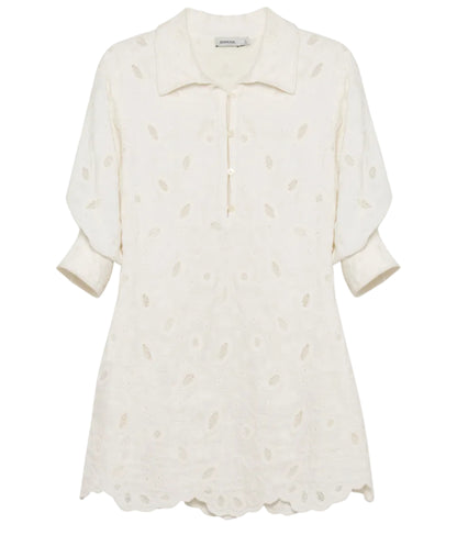 The Freya Linen Dress by Simkhai is a cream-colored, collared mini dress with three-quarter sleeves and a subtle eyelet pattern—ideal as an embroidered linen dress or stylish cover-up.