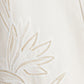 Close-up of the Ellery Bustier Midi Dress by Simkhai, featuring white broderie anglaise fabric with intricate embroidered floral patterns and openwork detailing.