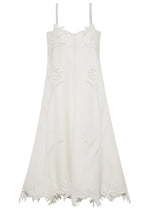 The Ellery Bustier Midi Dress by Simkhai is a sleeveless white linen-blend dress with thin straps, floral embroidery on the bodice and skirt, and a scalloped hem with delicate flower petal details.
