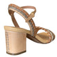 A single Ulla Johnson Sofia Sandal in tan and beige, featuring a block heel and woven strap design, viewed from the rear angle to highlight the ankle strap and stitching details in vegetable-tanned leather.