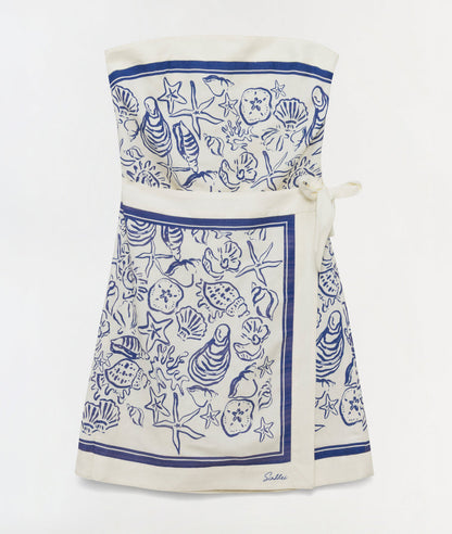 The Simkhai Darbie Linen Mini Dress features a blue seashell motif with marine-inspired shells, starfish, and sea creature illustrations, plus a waist tie and border design.