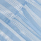 Close-up of light blue and white striped fabric with seam and gathered stitching from the Crissy Stripe Dress by Simkhai.