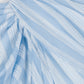 Close-up of the Simkhai Liorra Draped Midi Skirt in oxford blue with light blue and white stripes, showcasing gathered and pleated details that emphasize its wrap-effect design, texture, and pattern.