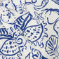Close-up of the Simkhai Audria Linen Midi Dress, showcasing its blue seashell and starfish print on white fabric with focus on the collar, button detail, and upper chest area.