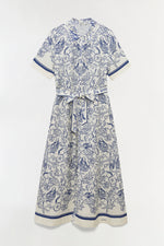 The Simkhai Audria Linen Midi Dress features a white short-sleeve design with a belted waist and blue marine-inspired seashell and starfish print, shown on a plain background.