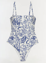 The Simkhai Ottilie Strapless One Piece features a blue seashell and marine life print on white, with a square neckline and adjustable shoulder straps.
