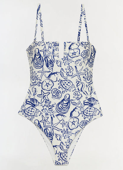 The Simkhai Ottilie Strapless One Piece features a blue seashell and marine life print on white, with a square neckline and adjustable shoulder straps.