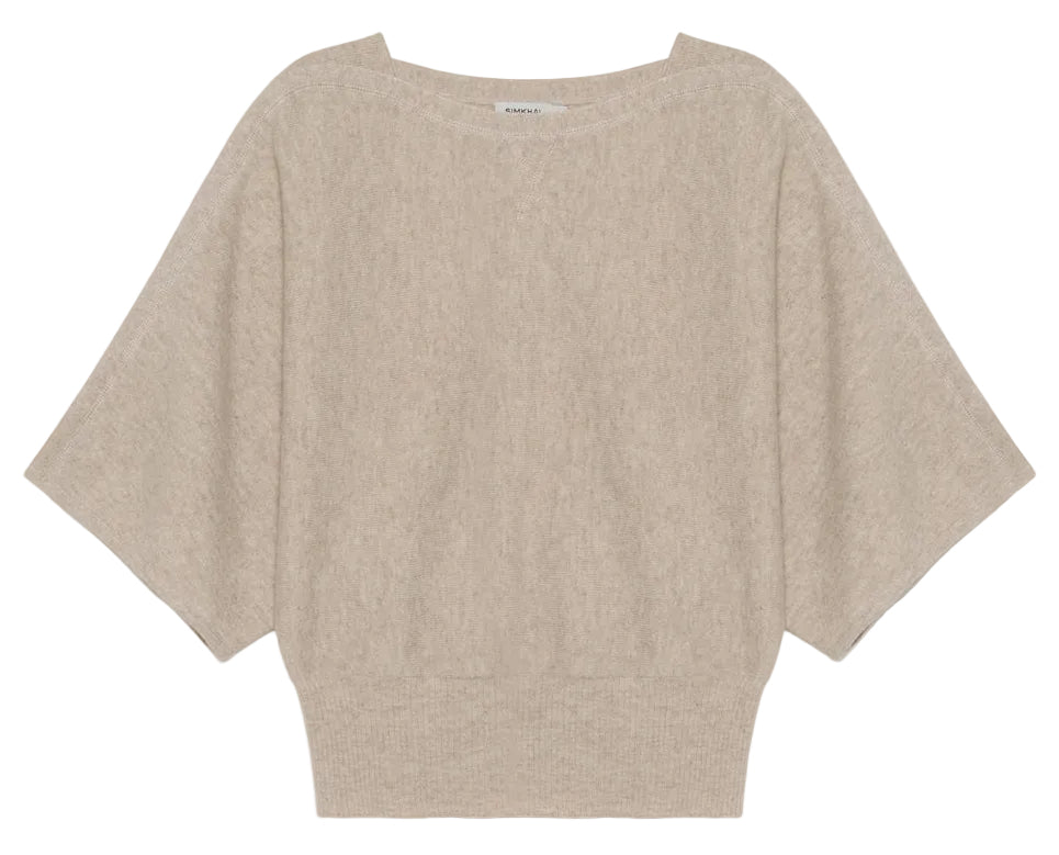 The Shai Tee by Simkhai is a beige, short-sleeved sweater featuring dolman sleeves, a wide neckline, loose fit, and ribbed waistband for a relaxed boxy silhouette.