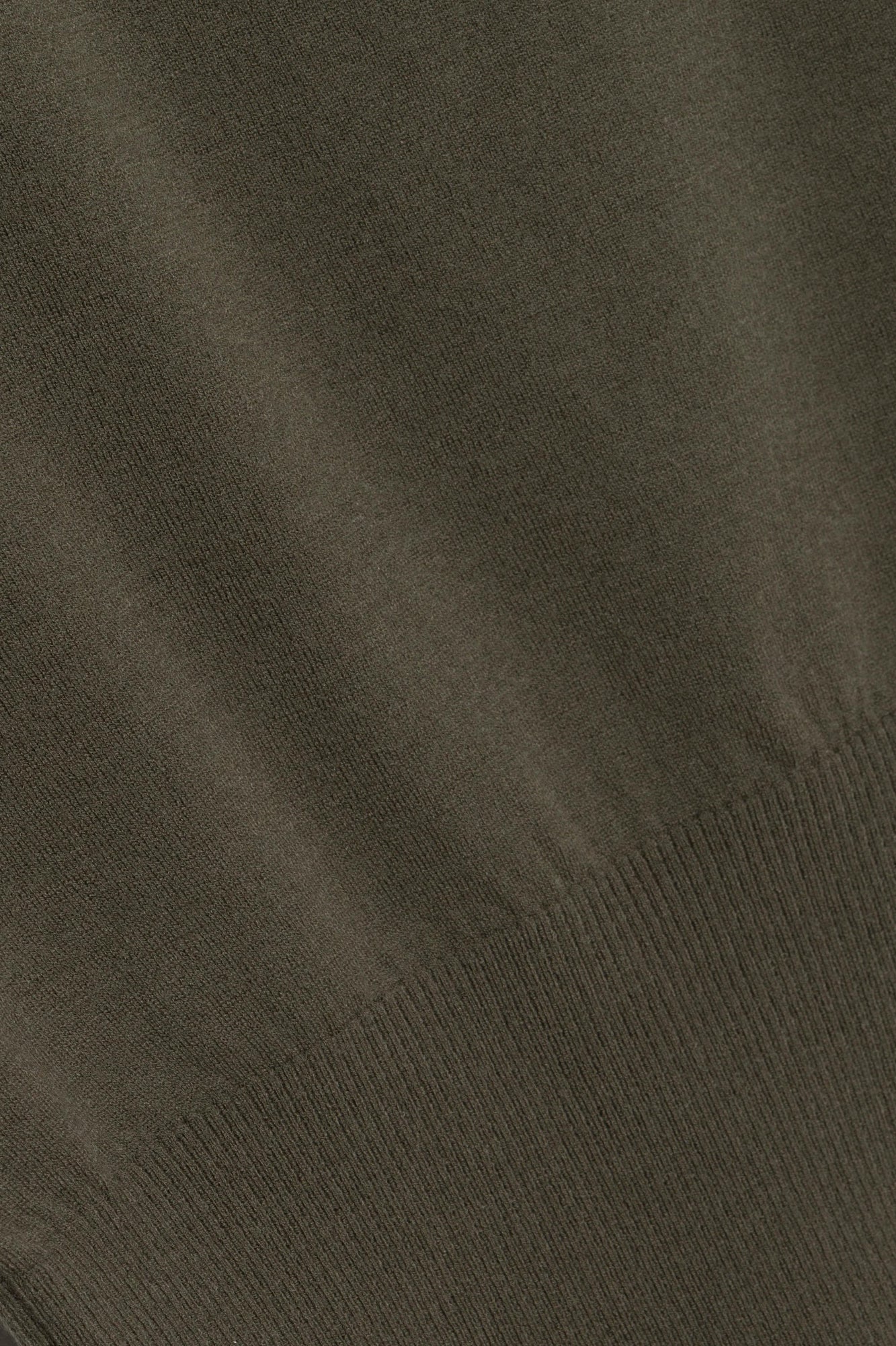 Close-up of the Lavina Draped Off Shoulder Sweater by Simkhai in olive green—featuring ribbed trim, visible stitching, and featherweight wool for a luxe textured look.