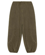 The Simkhai Freya Parachute Pant in olive green offers a loose fit with a drawstring waistband, visible seam details, and elasticated ankle cuffs.