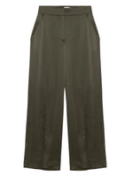 The Simkhai Kyra Wide Leg Pant in olive green features a high waist, tailored waistband, front pleats, side pockets, and a relaxed silhouette crafted from smooth, slightly shiny satin.