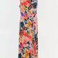 The Simkhai Acacia Jersey Midi Dress is a sleeveless, fitted silhouette midi dress in printed jersey, featuring a multicolored abstract pattern and side draping detail, displayed on a plain white background.
