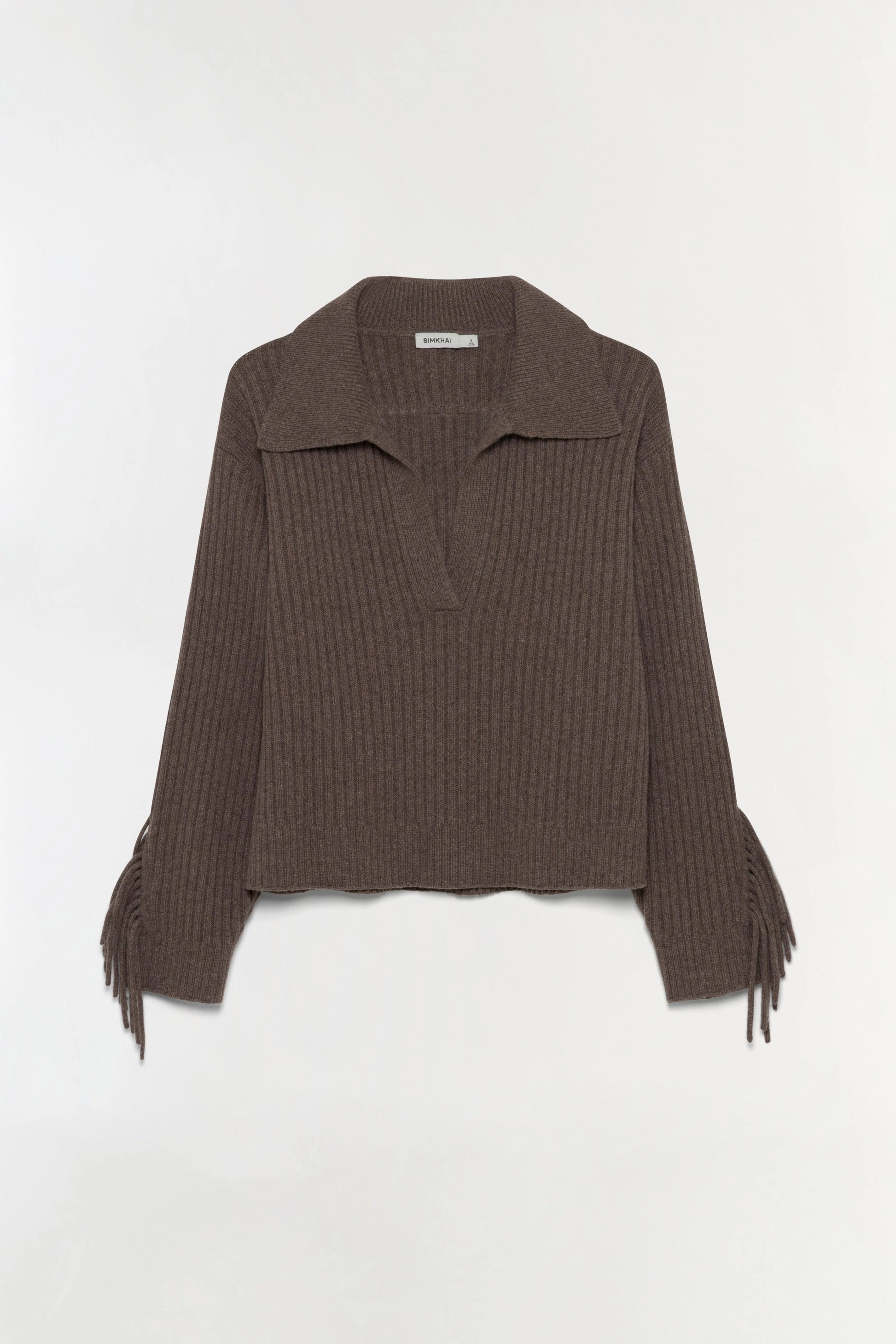 The Natalia Sweater by Simkhai is a long-sleeve, ribbed brown collared sweater with an open neckline, featuring Western-inspired detailing and fringe accents on the lower sleeves, shown against a plain white background.