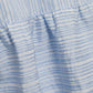 Close-up of light blue and white striped fabric with gathered seams and varied line thickness, featured on the Simkhai Cris Short Sleeve Shirt Dress.