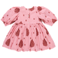 The Pink Chicken Girls' Embroidered Brooke Dress is a charming pink ensemble adorned with intricate red designs and star shapes. It features a buttoned-down front, gathered skirt, and puffed sleeves, seamlessly blending fall patterns with subtle floral embroidery for an elegant touch.