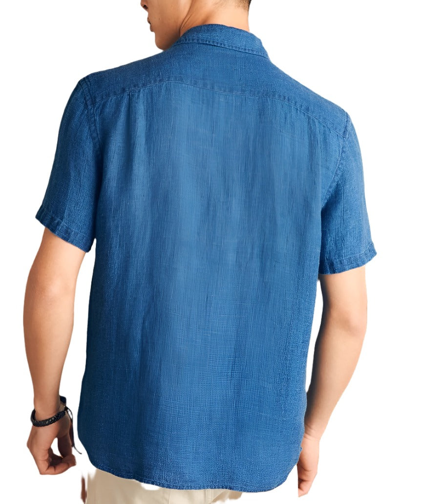 A person is wearing a lightweight summer shirt, seen from the back. The short-sleeved, blue button-up Faherty Short-Sleeve Linen Basketweave Shirt by Faherty is paired with light-colored pants and a black wristband on the left wrist.