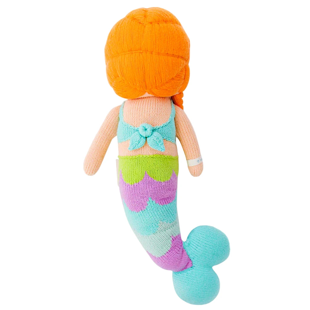 Isla the Mermaid - Little 13" by Cuddle + Kind features orange hair, a turquoise top, and a multicolored tail—shown from the back. Perfect for inspiring kindness and bringing magic to playtime! #IslaBirthday.