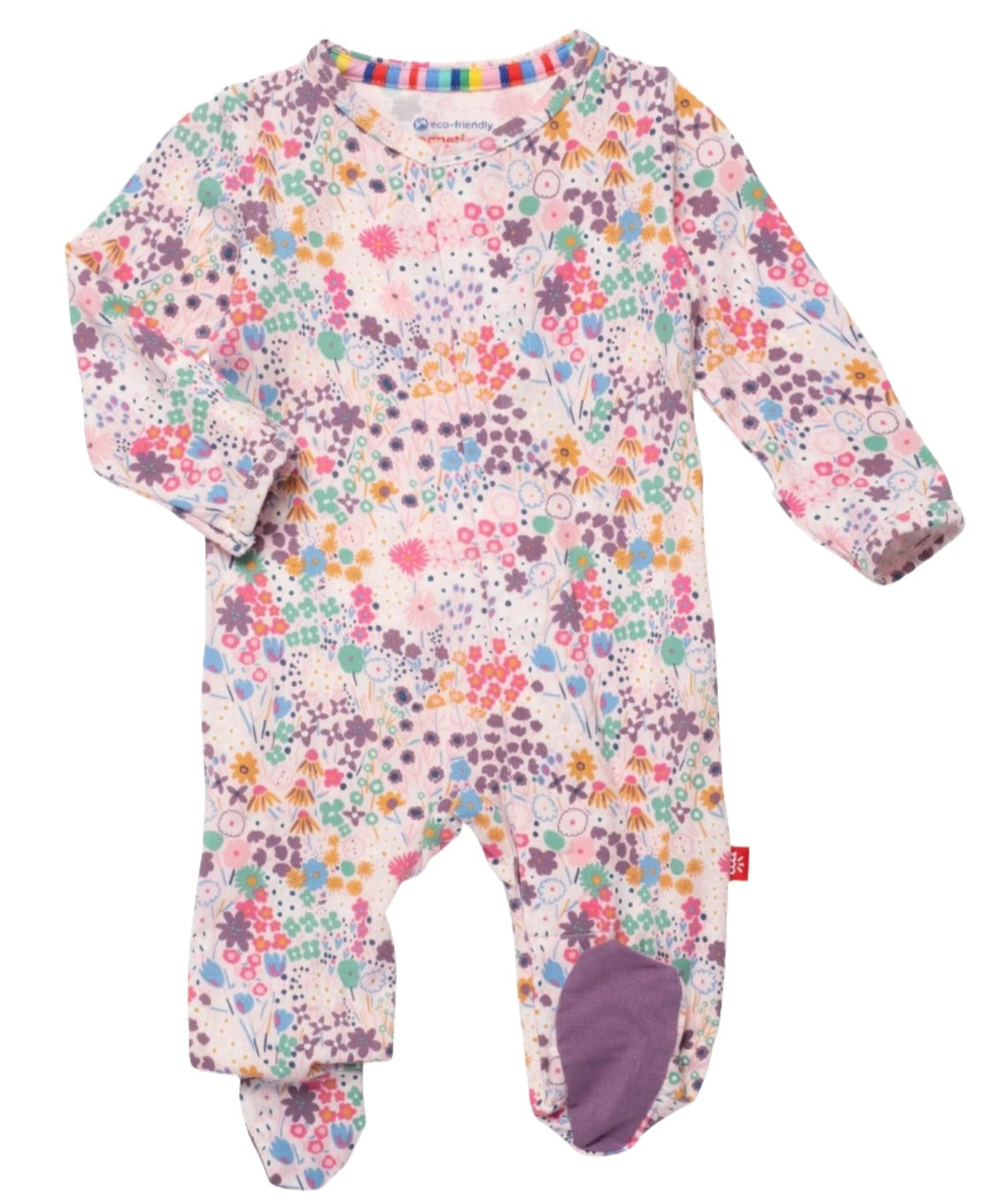 The Magnetic Me Isla Footie by Magnetic Me is a long-sleeved baby onesie adorned with a vibrant floral pattern displaying hues of purple, pink, yellow, and blue flowers. Crafted from eco-friendly TENCEL™, this onesie features integrated foot coverings, a round neckline, and convenient magnetic closures.