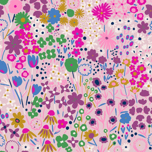 The Magnetic Me Isla Footie features a colorful pattern of various flowers and plants in shades of pink, purple, green, blue, and yellow, set against a light background made from eco-friendly TENCEL™.