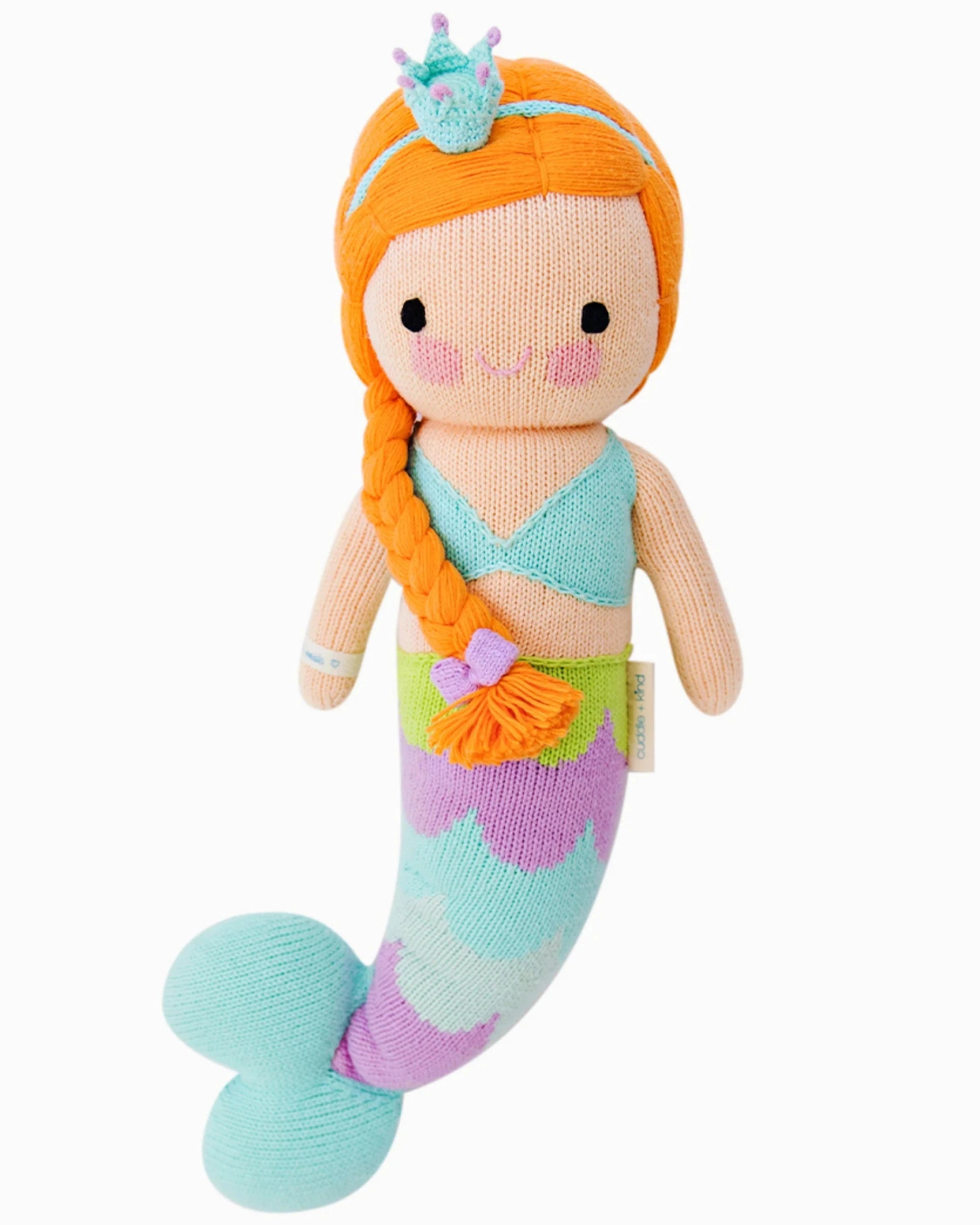 Isla the Mermaid - Little 13" by Cuddle + Kind features orange hair, a blue crown, a braided side ponytail, a light blue top, and a purple, green & blue tail—perfect for inspiring kindness and magical adventures.
