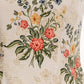 Close-up of the Agua By Agua Bendita Pistilo Dress, a cream-colored poplin midi dress featuring a multicolored floral print with red, yellow, and blue flowers and green leaves.