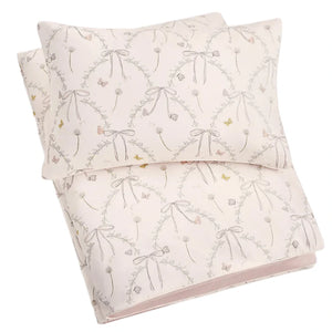 The Gooselings Bows & Butterfly Kisses Toddler Duvet with Insert, featuring pink and grey bows and floral patterns on a light background, adds a cozy touch to any big-kid bed.